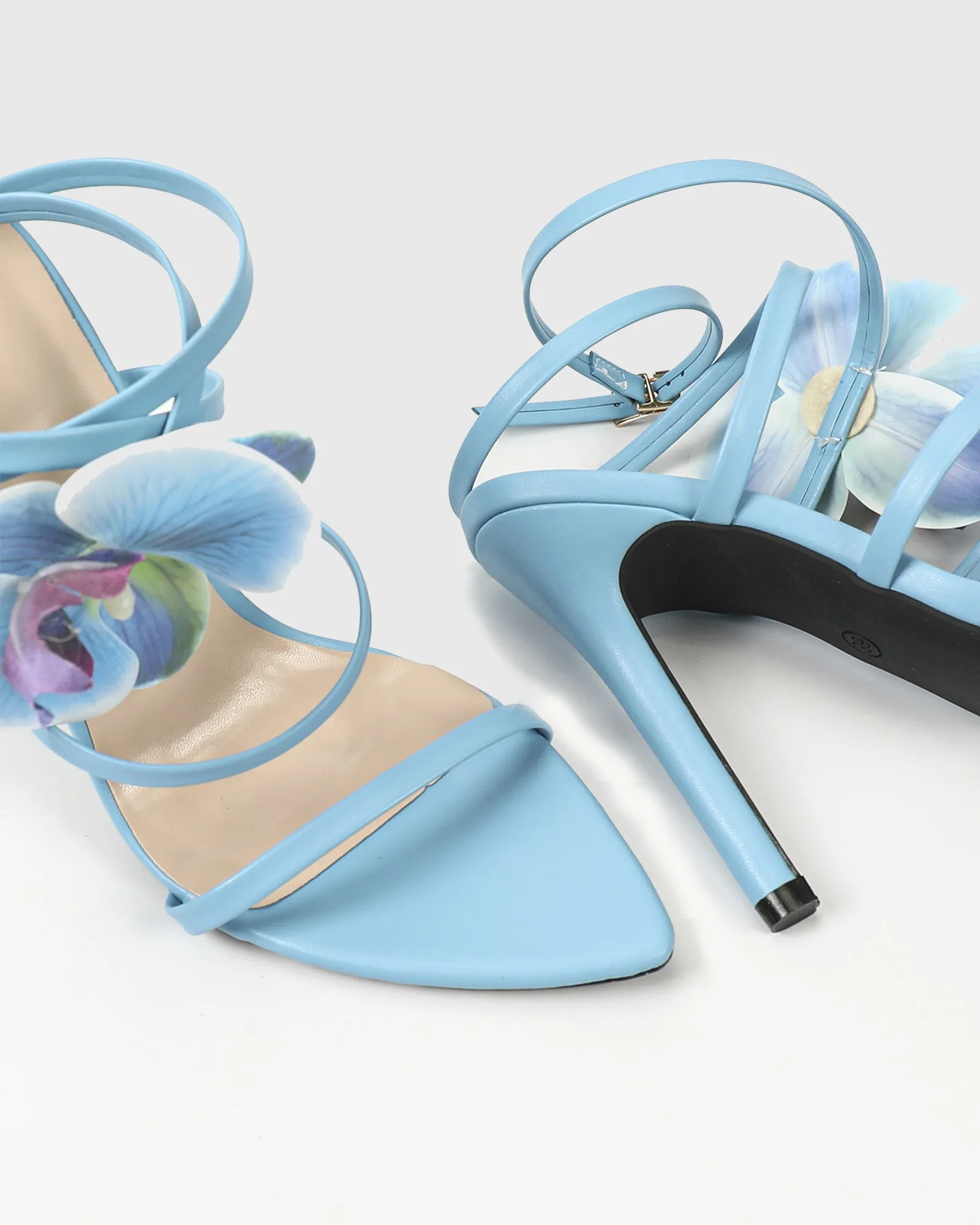 Oria Flower Embellished Cross Strap Sandals In Blue